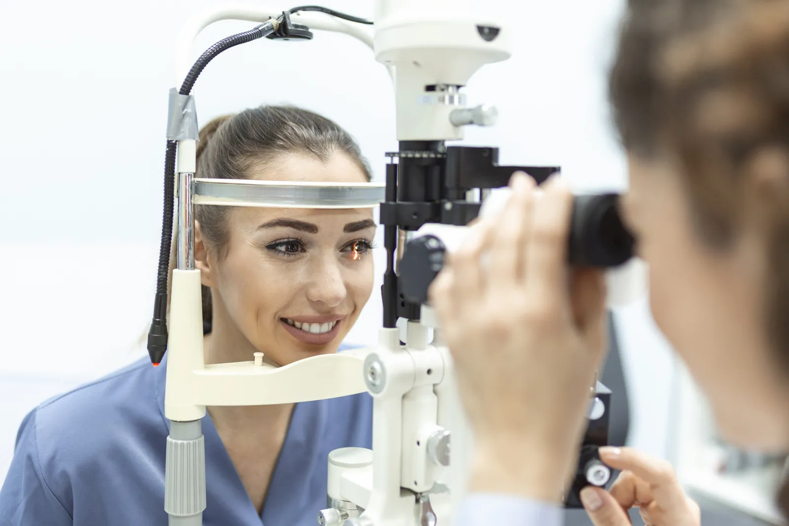 Ophthalmologist examining a patient's eyes with a slit lamp