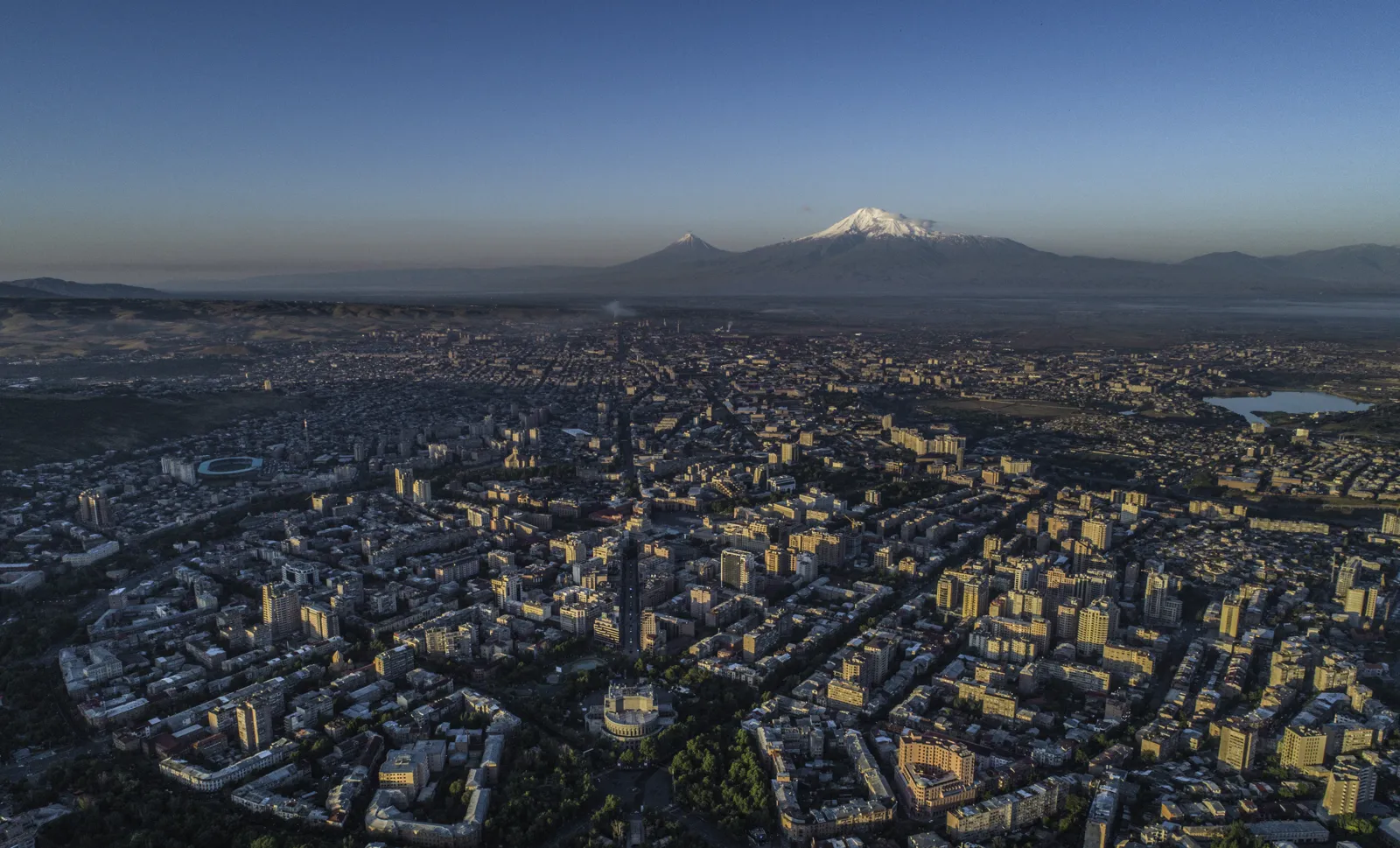 Aerial view of Yerevan at dusk with Mount Ararat in the background