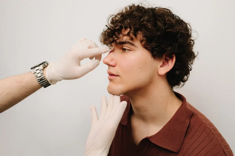 ENT doctor examining the nasal septum of a patient with breathing difficulty