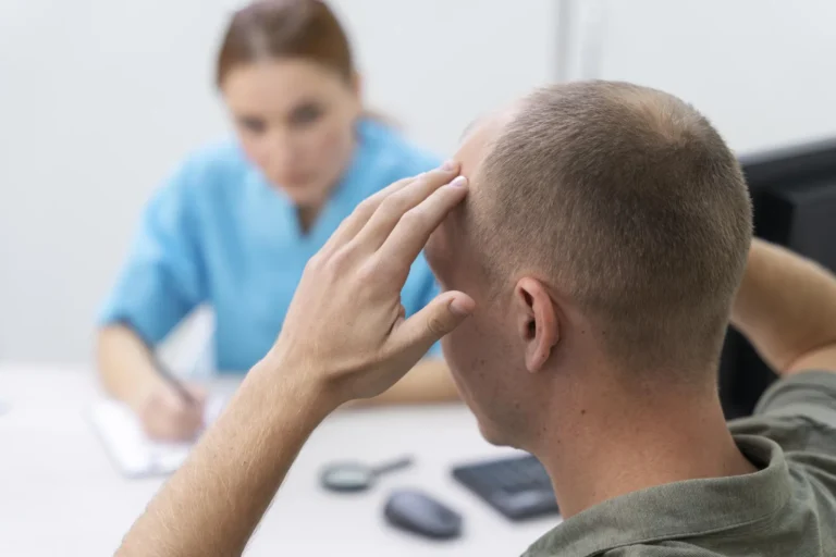 Man showing his thinning area to the doctor during a hair follow-up visit