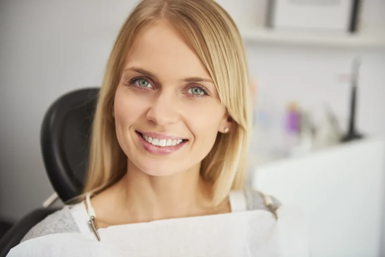 Smiling, relaxed patient sitting in a dental clinic chair