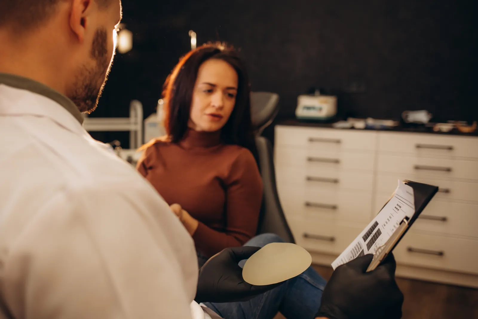 Patient talking with her plastic surgeon about breast surgery