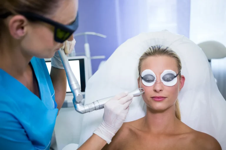 Patient with eye shields receives a facial device treatment