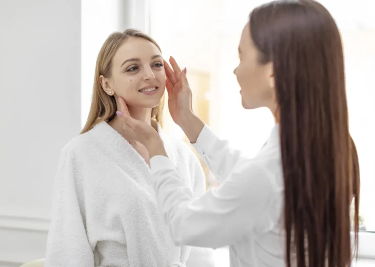 Aesthetic specialist assesses a client's face before treatment