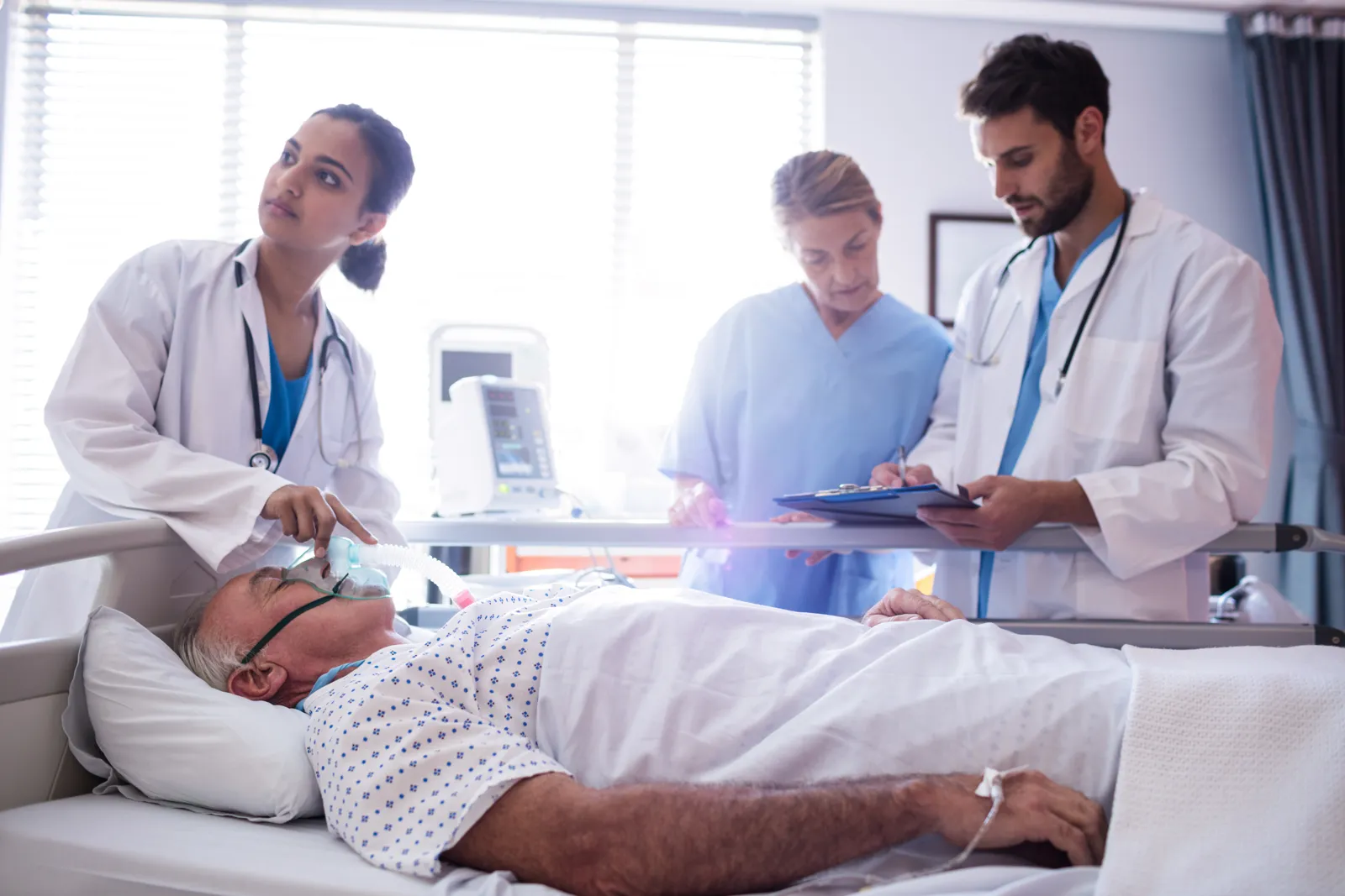 Medical team places an oxygen mask on a resting patient